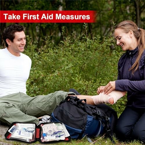 Two people practicing first aid outdoors with a kit.